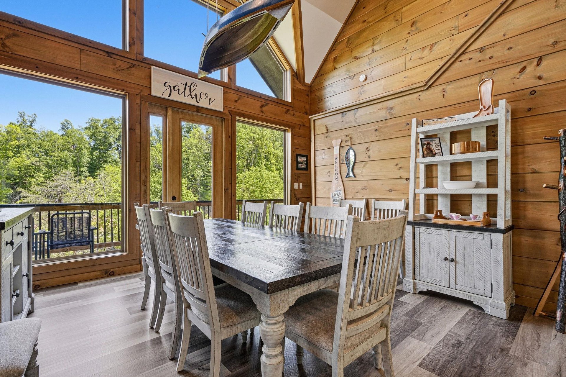 Gather around your rustic dining table where warm wood beams frame forest views through floortoceiling windows—perfect for memorable meals together.