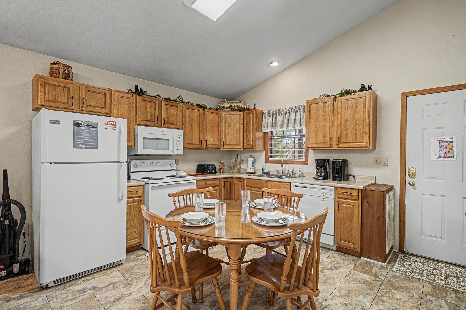 Your fully equipped kitchen invites homecooked meals with warm wood cabinets and a charming dining table for memorable gatherings.