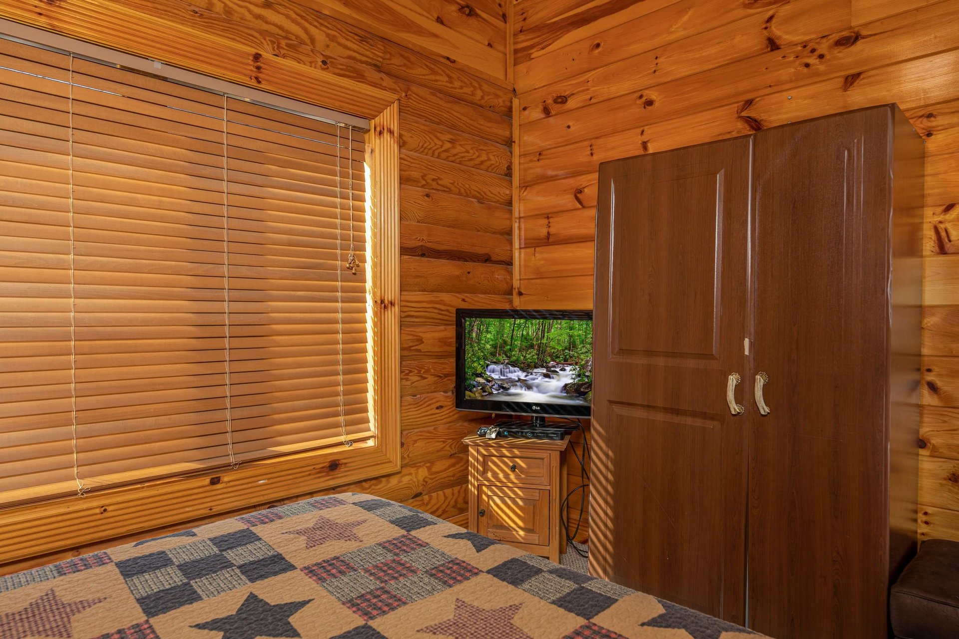 TV and armoire in a bedroom at Gone Fishin, a 2bedroom cabin rental located in Pigeon Forge