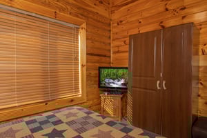 TV and armoire in a bedroom at Gone Fishin, a 2bedroom cabin rental located in Pigeon Forge