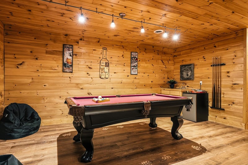 Challenge your friends to a game in your private billiard room, complete with warm wood paneling and cozy lighting perfect for evening entertainment.