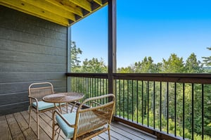 Sip your morning coffee on your private balcony, surrounded by treetops and clear blue skies. A perfect spot to unwind and soak in peaceful forest views.