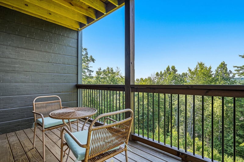 Sip your morning coffee on your private balcony, surrounded by treetops and clear blue skies. A perfect spot to unwind and soak in peaceful forest views.