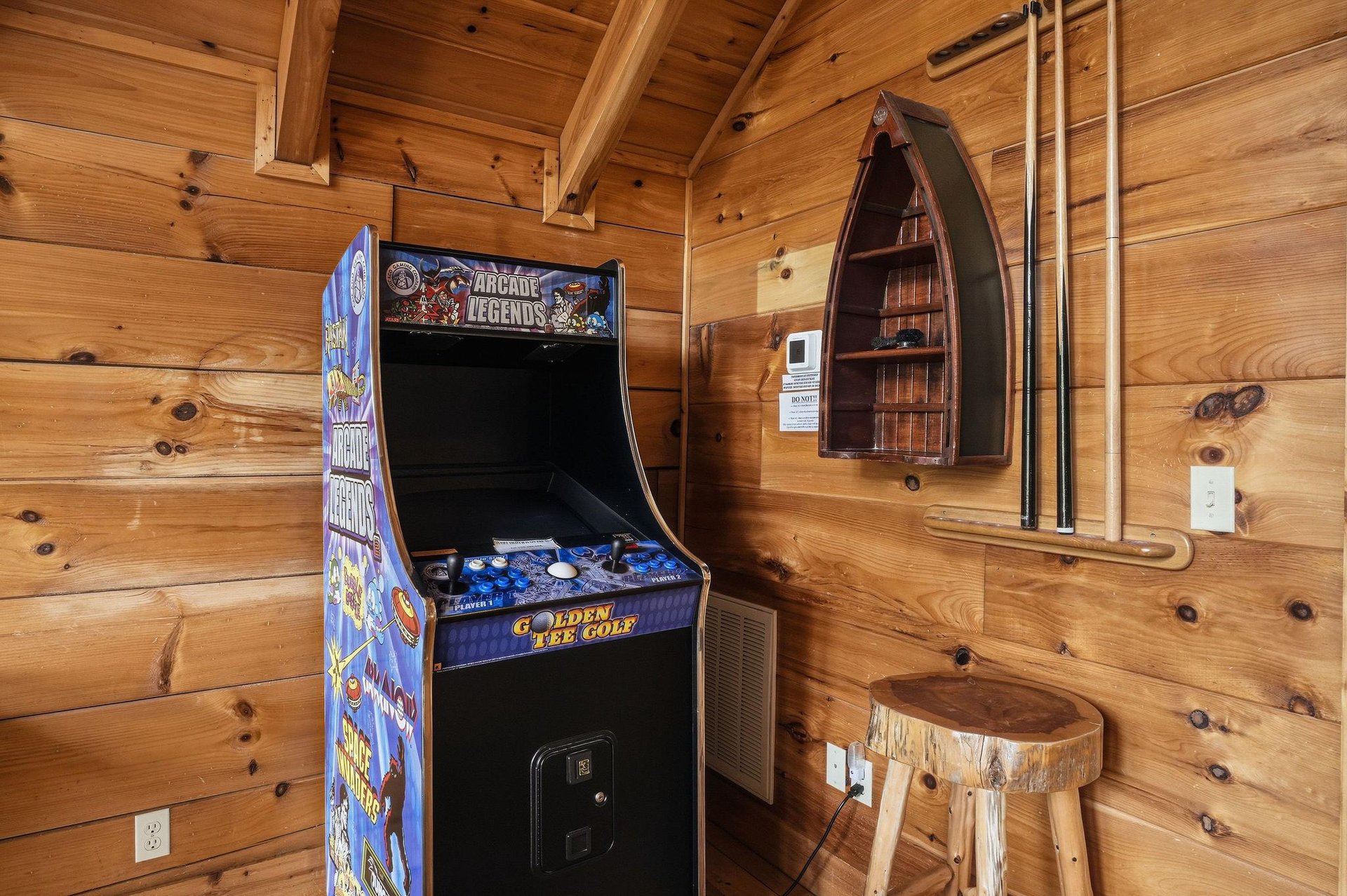 Challenge your friends to a friendly competition on the vintage arcade machine, a fun throwback that adds nostalgic entertainment to your cabin getaway.