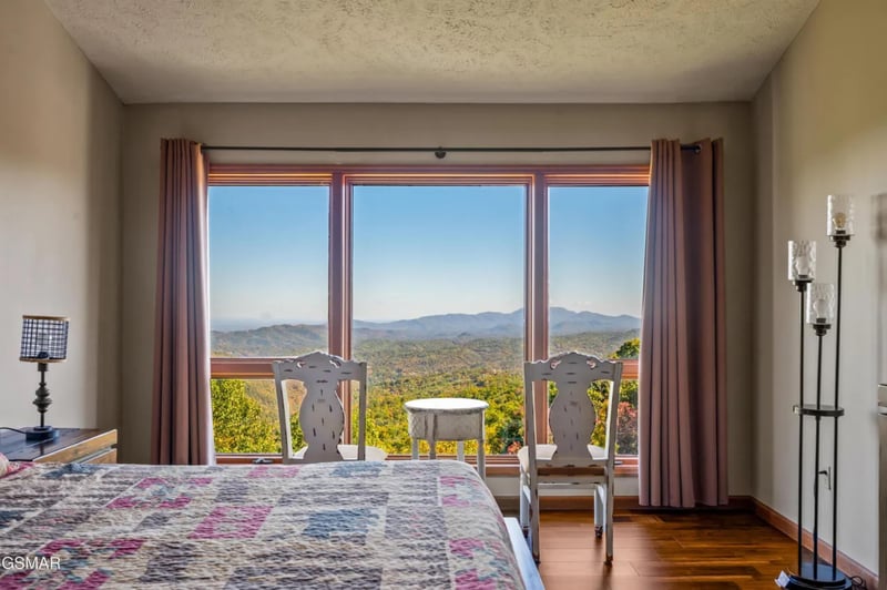 Wake up to breathtaking mountain views from your cozy bedroom, where panoramic windows frame the rolling hills perfectly.