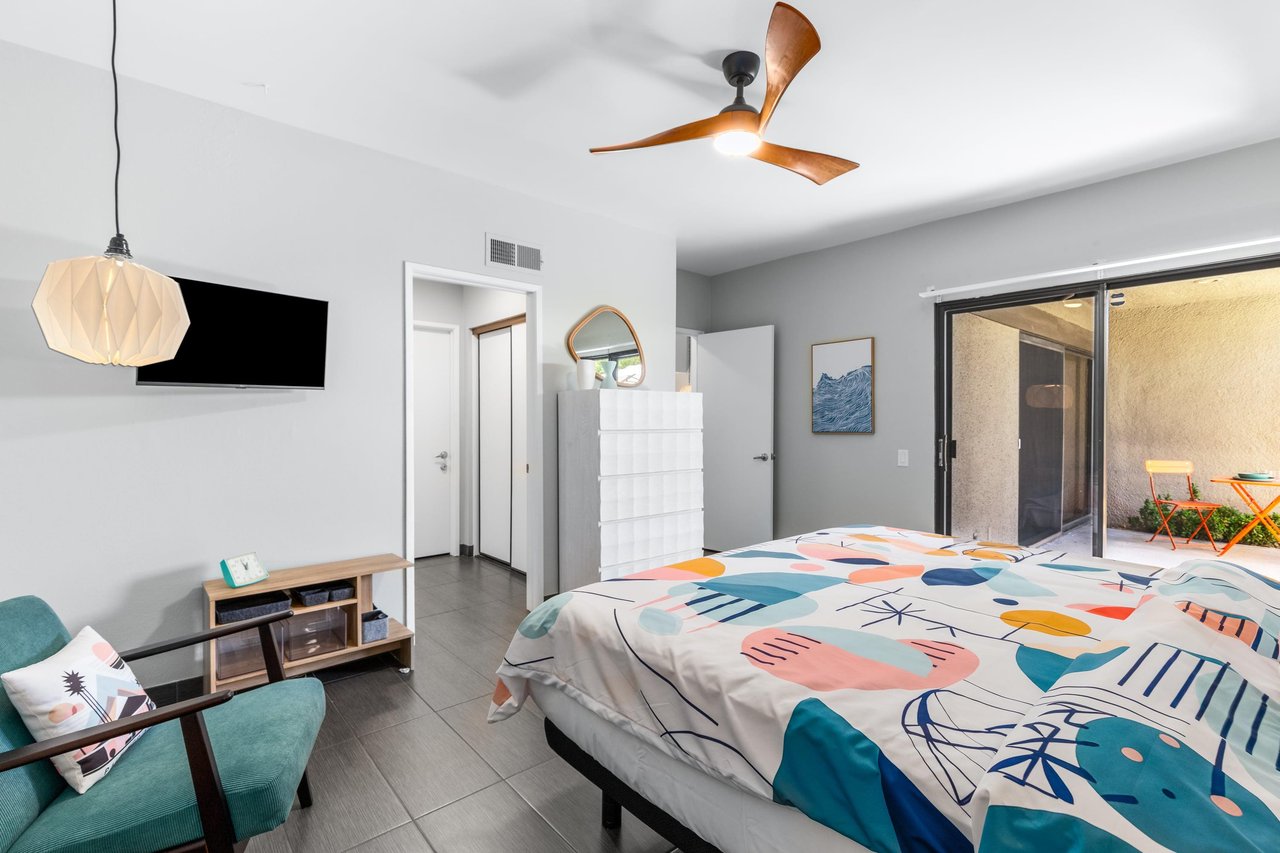 California king bed, smart TV, patio access, and ensuite bathroom.