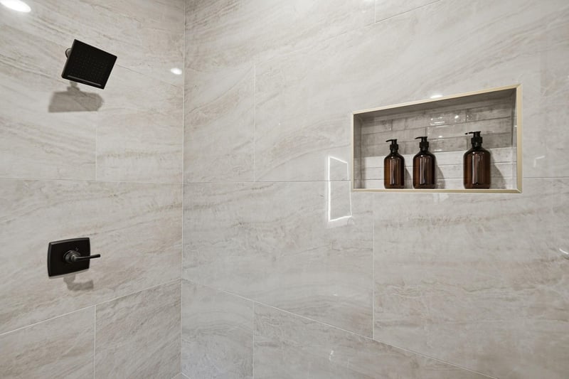 Step into your luxurious marble shower with premium amenities and sleek black fixtures for an indulgent spalike experience.