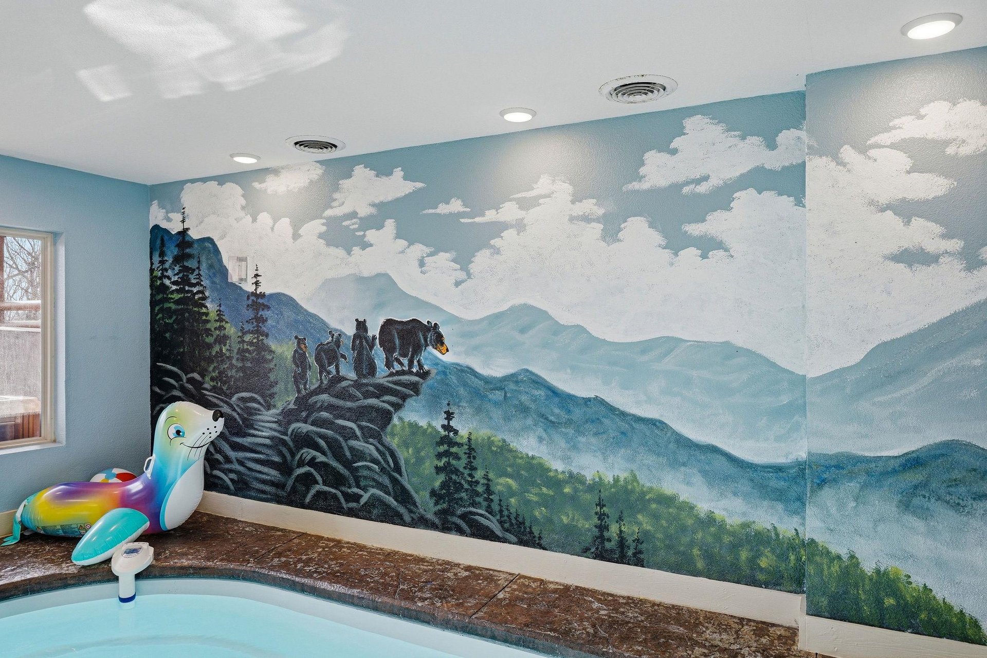 Your kids will love this whimsical mountain mural while enjoying splash time in the pool area.