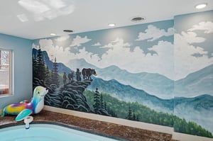 Your kids will love this whimsical mountain mural while enjoying splash time in the pool area.
