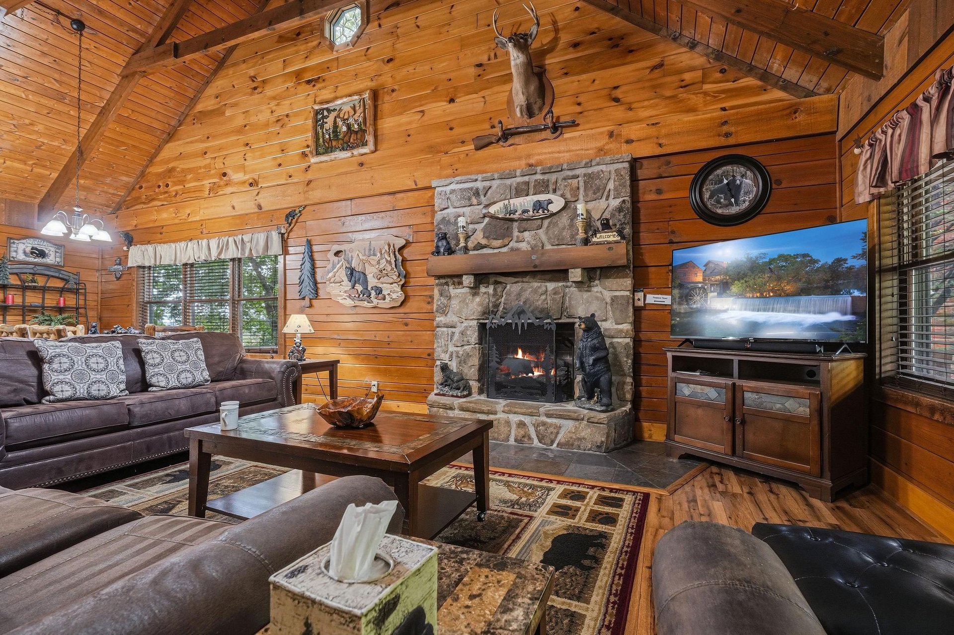 Sink into plush leather sofas by the warmth of your stone fireplace, where the rustic charm of natural wood and cozy cabin ambiance invite you to unwind completely.