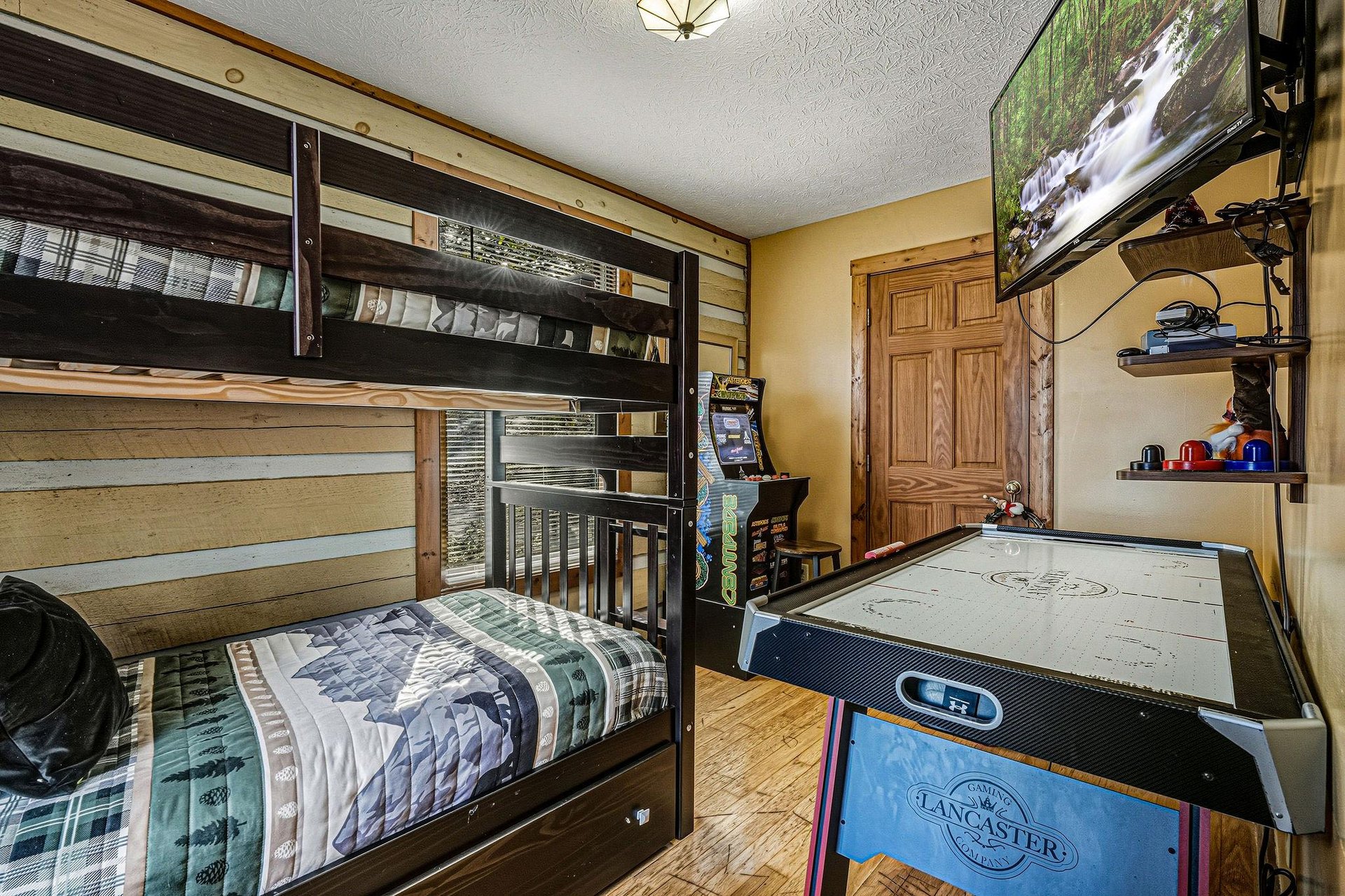 Your kids will love this funfilled room with cozy bunk beds, arcade games, and air hockey for endless entertainment.