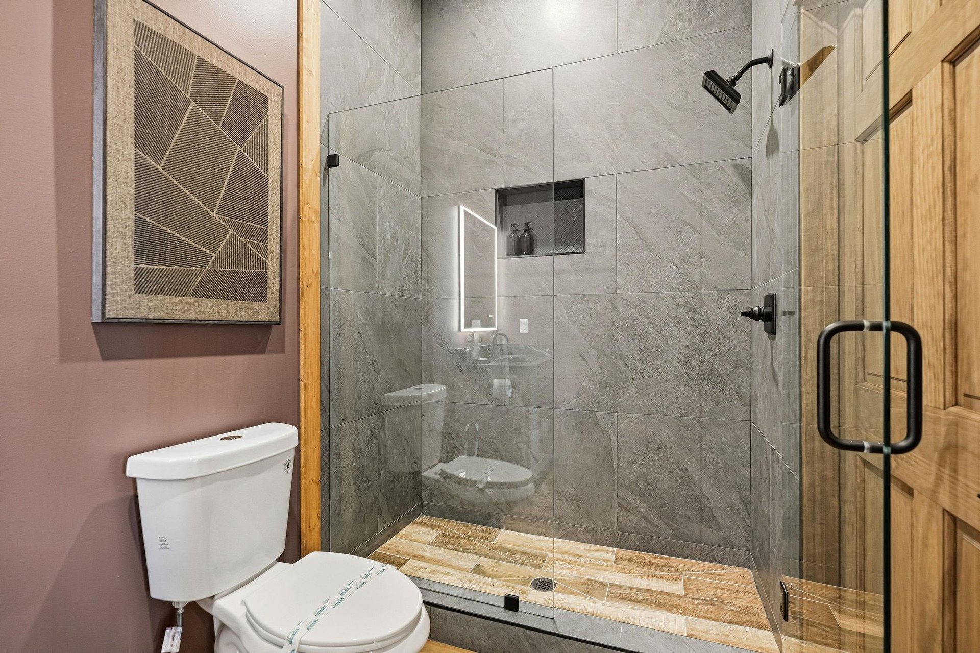 Step into your modern sanctuary with elegant marbletiled shower, rainfall head, and stylish fixtures for the perfect refresh.