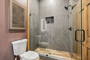 Step into your modern sanctuary with elegant marbletiled shower, rainfall head, and stylish fixtures for the perfect refresh.