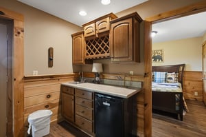 Your fully equipped kitchen features warm wood cabinetry, granite countertops, and modern appliances for preparing meals during your stay.