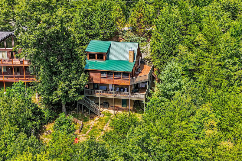 This mountain retreat sits nestled among towering trees, offering privacy and natural beauty in a serene forested setting.