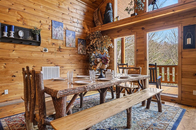 Gather around this rustic dining table where memorable meals await in your cozy cabin retreat.