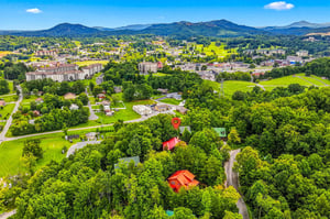 Nestled amid lush rolling hills and forested slopes, the property sits in a scenic mountain valley surrounded by nature and just minutes from the vibrant town center.