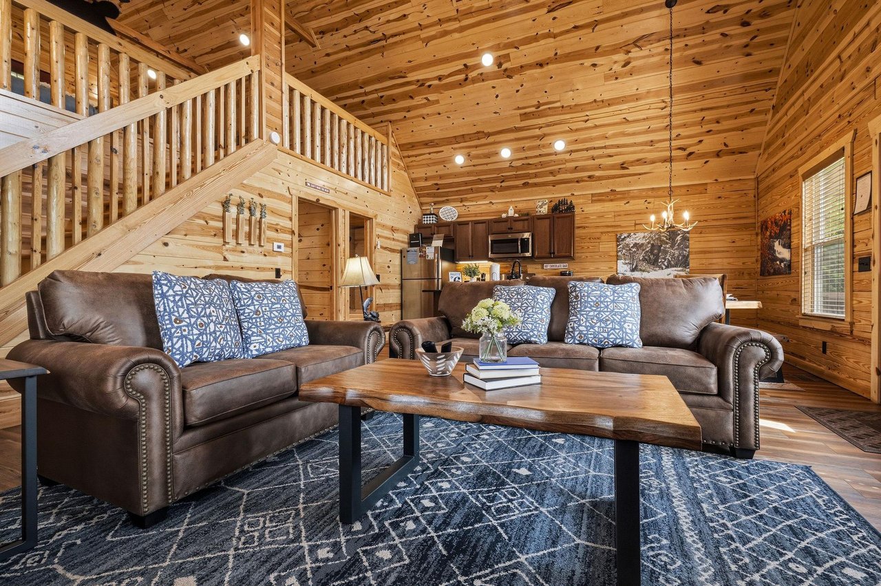 Sink into plush leather sofas and unwind in your warm, woodwrapped living space with loft views, a full kitchen, and inviting touches that make you feel right at home.