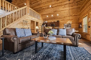 Sink into plush leather sofas and unwind in your warm, woodwrapped living space with loft views, a full kitchen, and inviting touches that make you feel right at home.