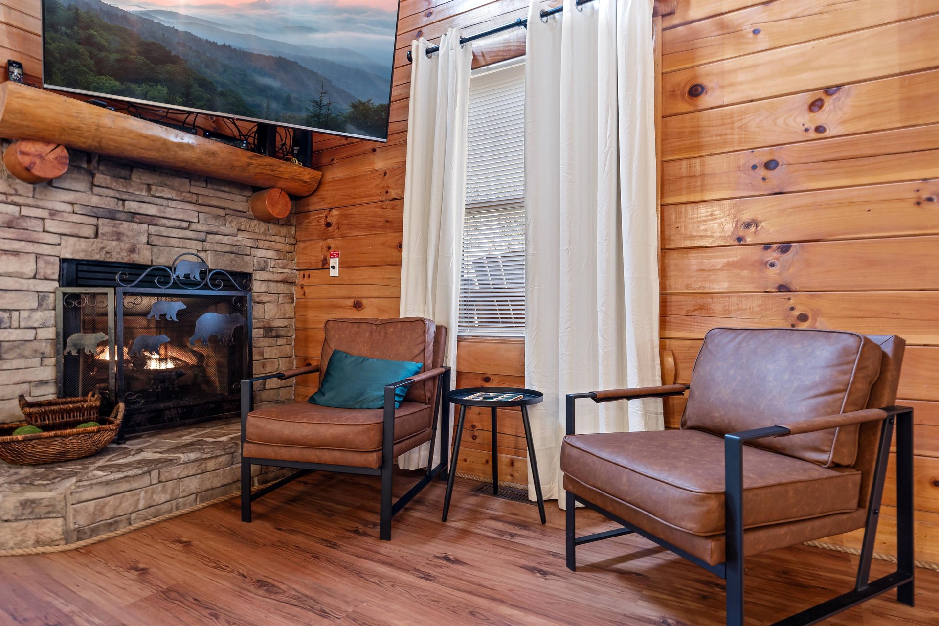 Cushioned chairs by stone fireplace