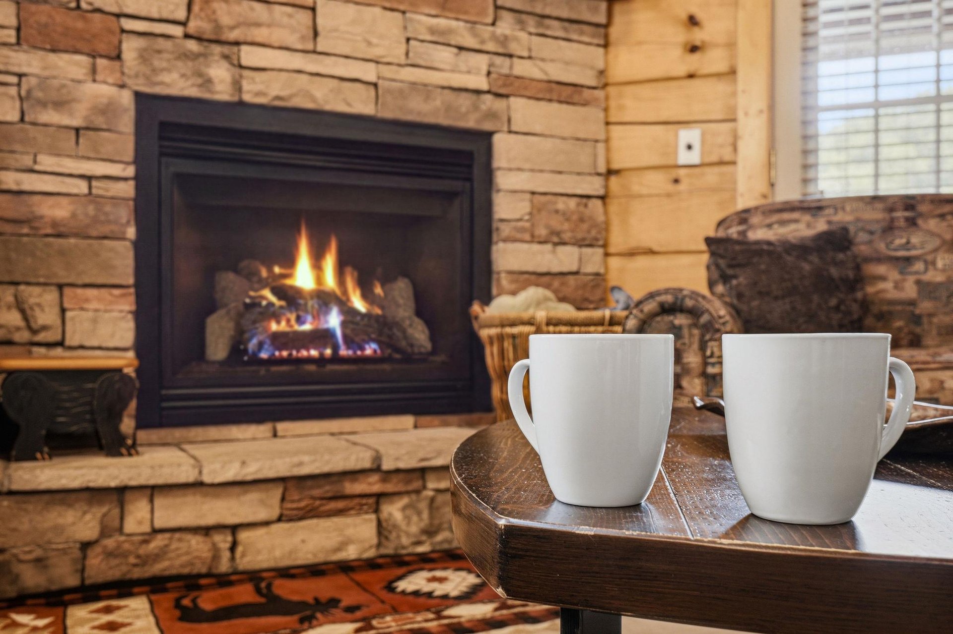 Warm up by the crackling fireplace with a steaming cup of coffee in your hands, surrounded by rustic stone and wood that invites you to unwind completely.