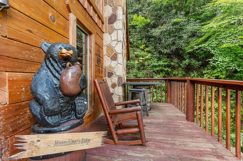 Deck rocking chair with bear statue