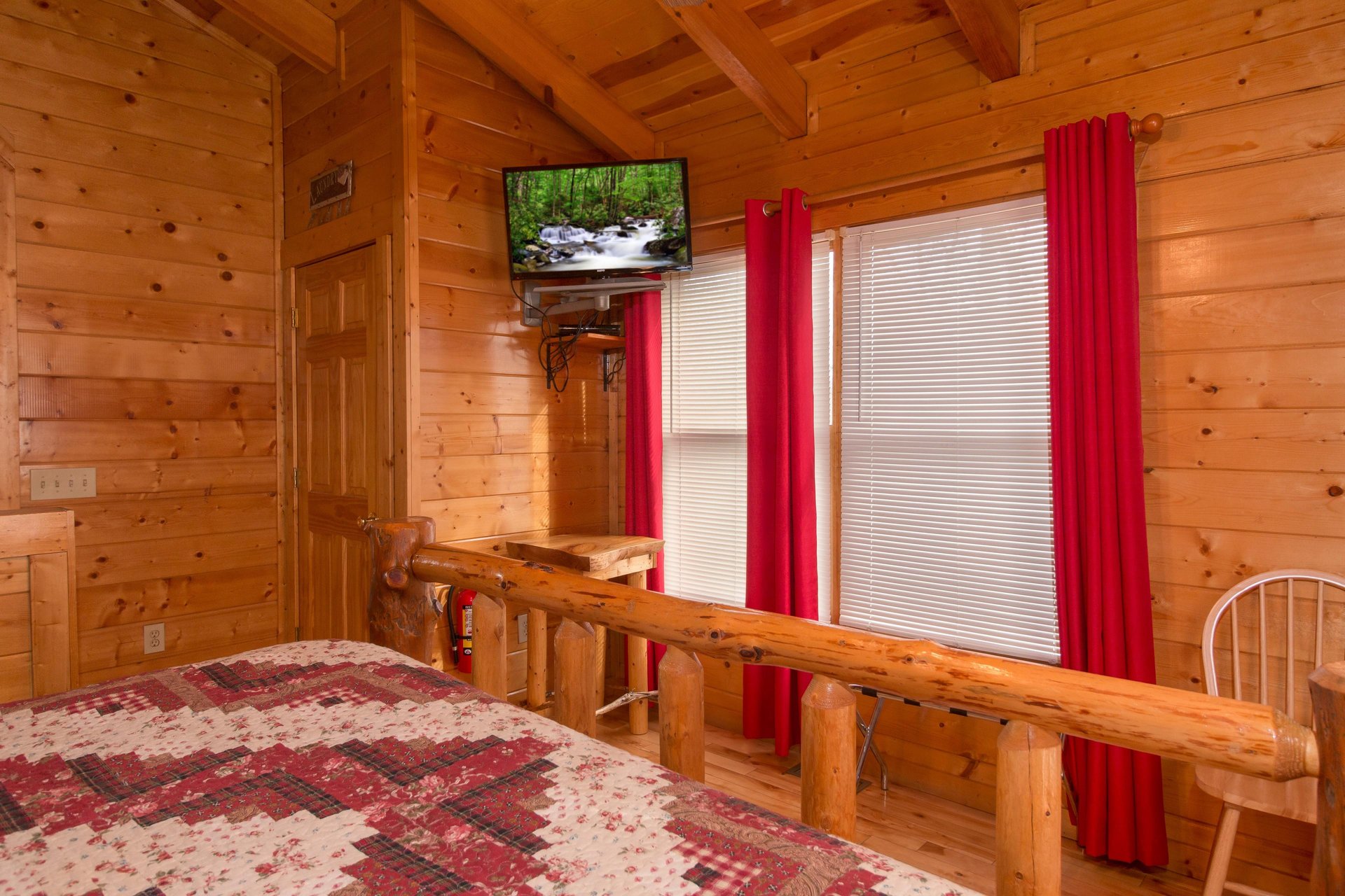 Table and TV in a bedroom at Country Bears Getaway, a 3bedroom cabin rental located in Gatlinburg