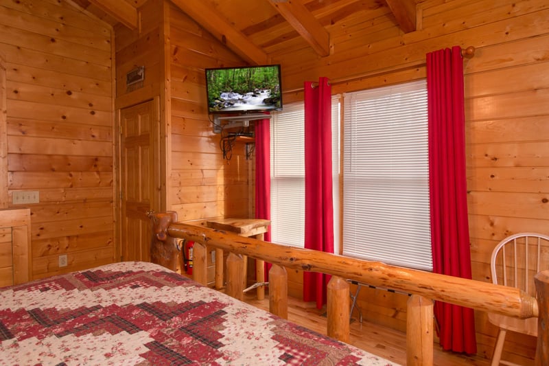 Table and TV in a bedroom at Country Bears Getaway, a 3bedroom cabin rental located in Gatlinburg