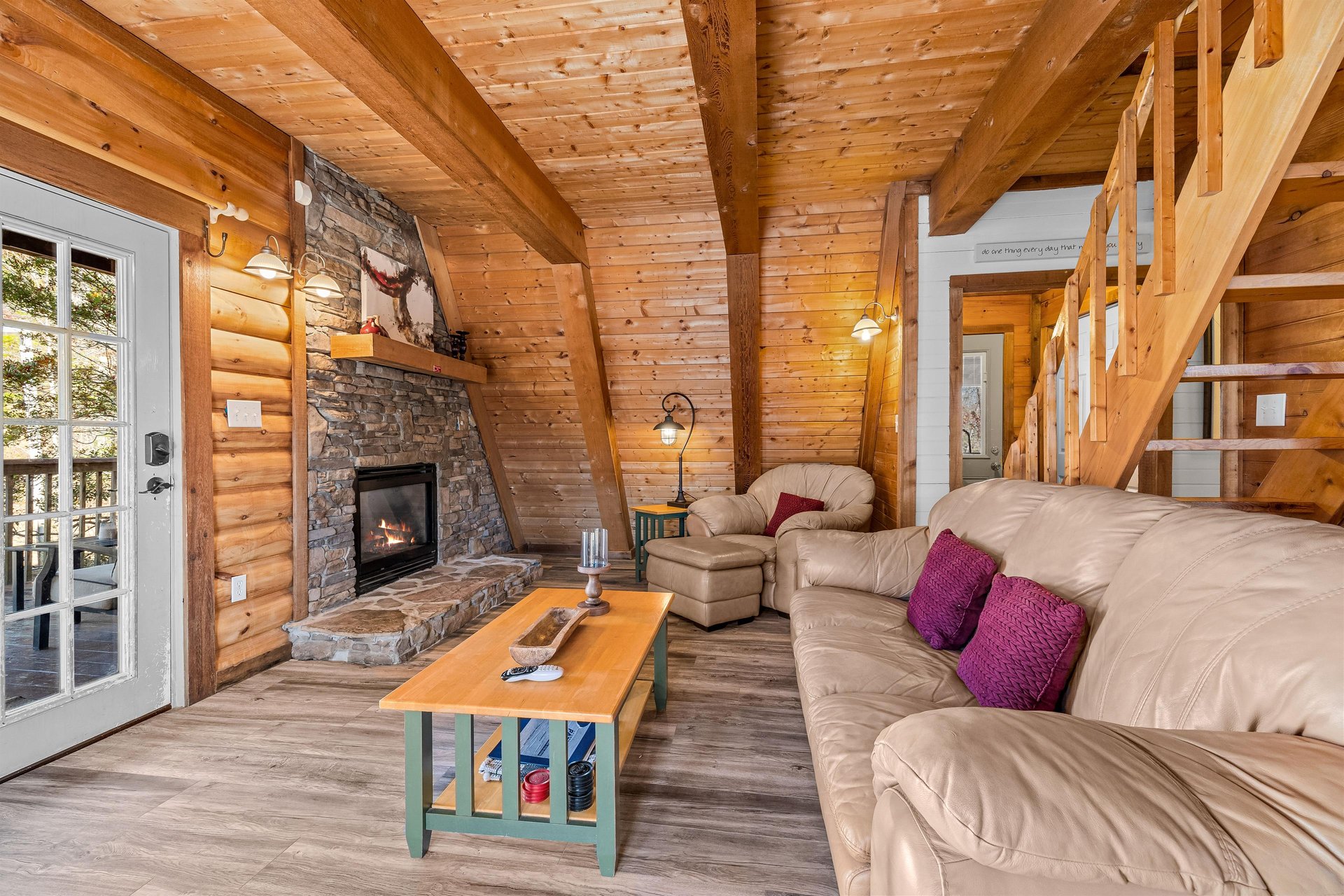Sofa, fireplace, and chair in the living room at Living on Love, a 2 bedroom cabin rental located in Pigeon Forge
