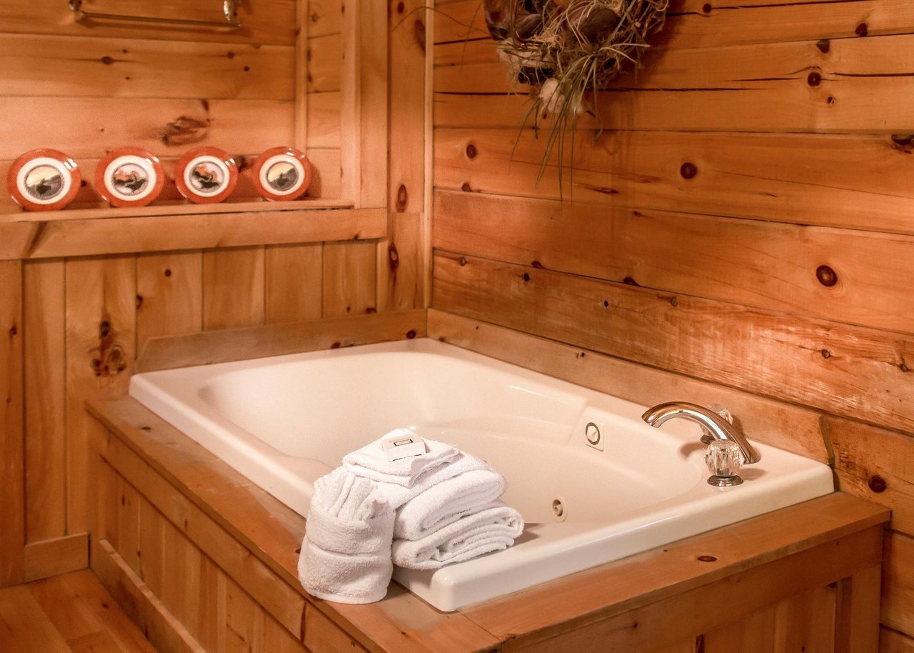 The second bedroom is located at the top of the spiral staircase and features a queen bed and soaking tub.
