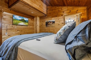 Sink into crisp linens under soaring woodplanked ceilings in your private bedroom retreat, where rustic charm meets modern comfort.