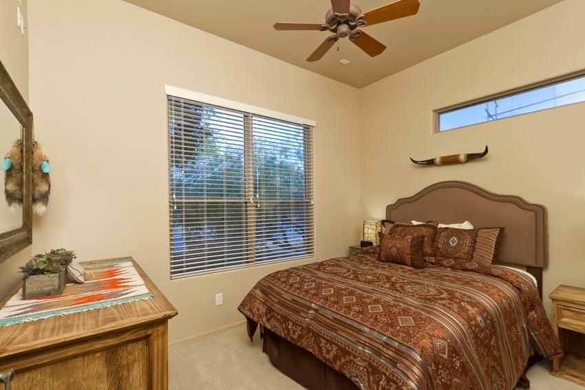 Rich chocolate tones cover this bed and warm the bedroom