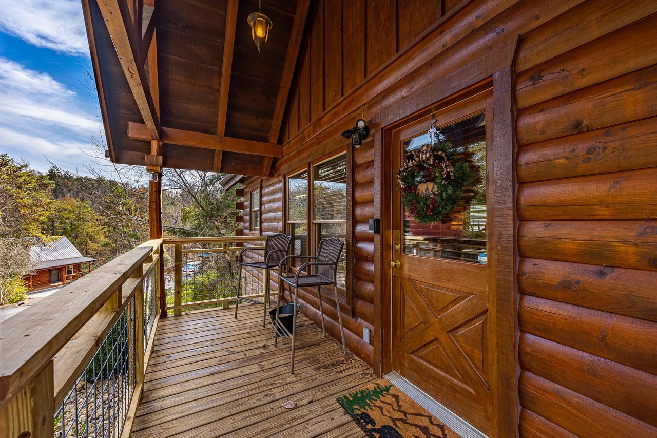 Covered Deck and front door at Bear Feet Retreat, a 1 bedroom cabin rental located in pigeon forge
