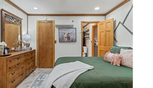 Unwind in your cozy bedroom featuring rustic wood accents, soft linens, and thoughtful touches that create the perfect retreat after exploring.