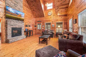Sofa and chair in the living room at Moonshine Memories, a 2 bedroom cabin rental located in Gatlinburg
