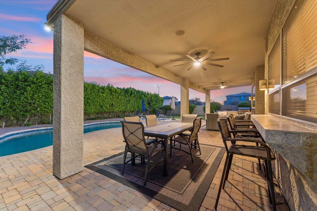 Plenty of outdoor seating on the patio overlooking the pool area, with outdoor ceiling fans.