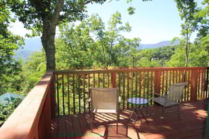 Two chairs and a drink table overlooking the mountains at Bushwood Lodge, a 3bedroom cabin rental located in Gatlinburg