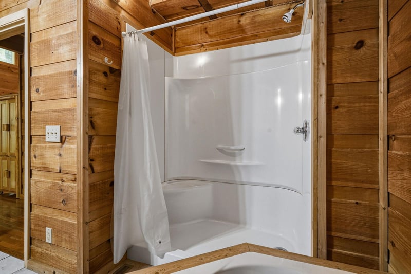 Step into your private shower with a cozy cabin feel—rustic wood walls meet modern comfort, giving you a refreshing retreat after your adventures.