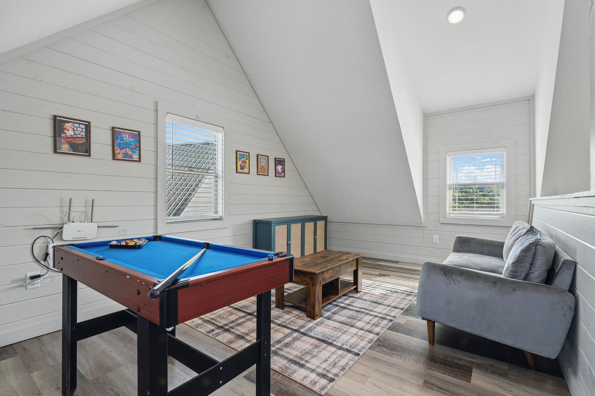 small pool table and sitting area with natural lighting