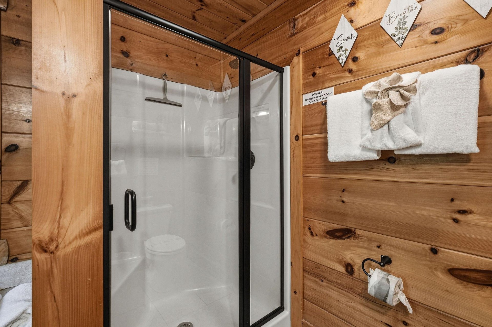 Step into your private shower after a day of adventure, surrounded by warm wood and thoughtfully arranged towels waiting for you.