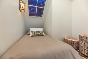 Twin bedroom with woodsy decor at Mountain Celebration, a 4 bedroom cabin rental located in Gatlinburg
