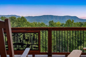 Unwind on a private deck surrounded by lush forest with sweeping views of majestic mountains. This peaceful retreat offers the perfect spot to relax and soak in natures beauty.