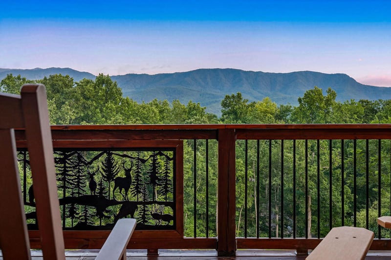 Unwind on a private deck surrounded by lush forest with sweeping views of majestic mountains. This peaceful retreat offers the perfect spot to relax and soak in natures beauty.