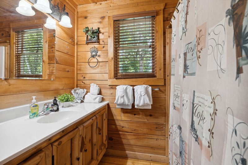 Single vanity sink across bathtub