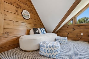 Unwind in your cozy loft seating area with exposed beam ceilings and soft textures perfect for relaxation.