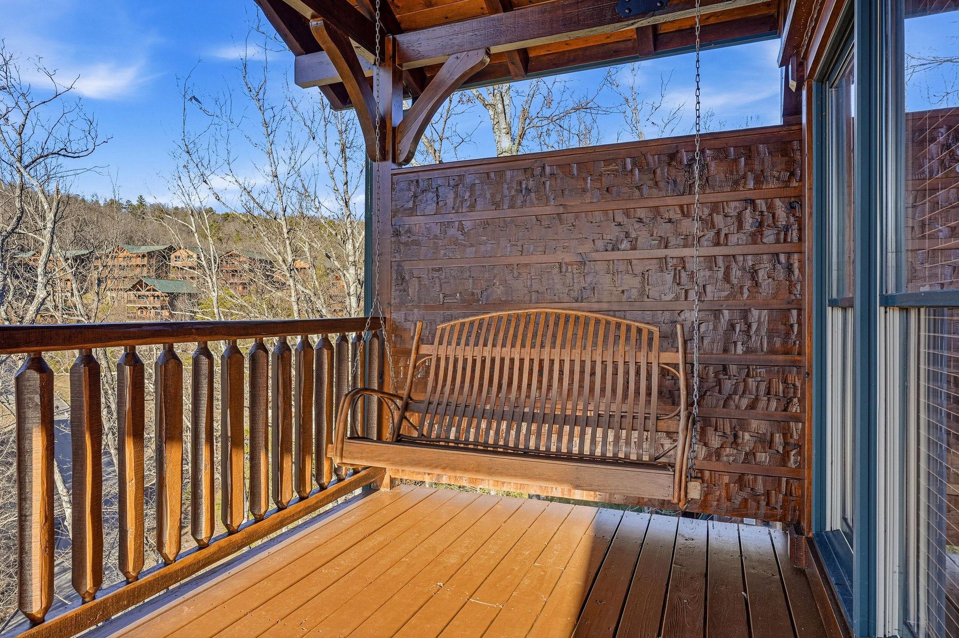 Sway gently on your private porch swing as you take in peaceful mountain views and listen to the rustle of bare branches under a clear blue sky—a perfect spot for morning coffee or evening reflection.
