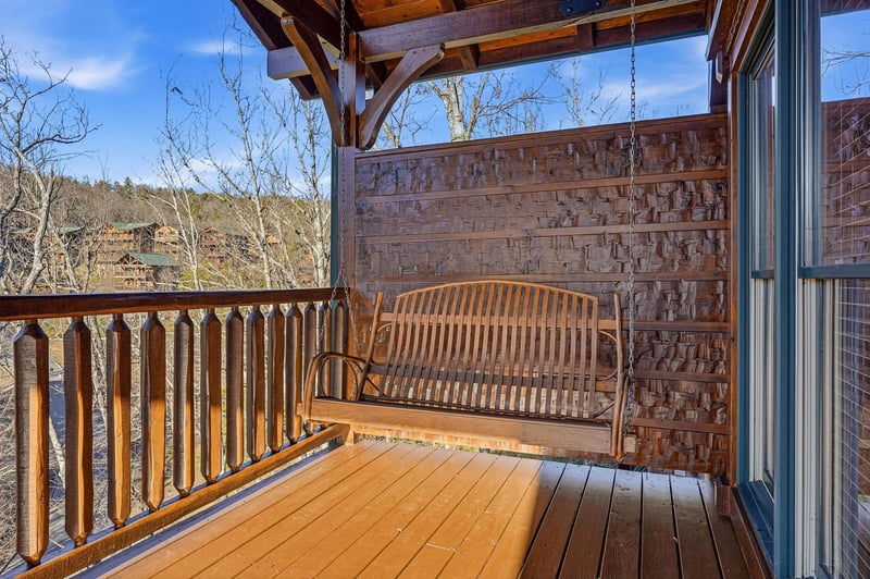Sway gently on your private porch swing as you take in peaceful mountain views and listen to the rustle of bare branches under a clear blue sky—a perfect spot for morning coffee or evening reflection.