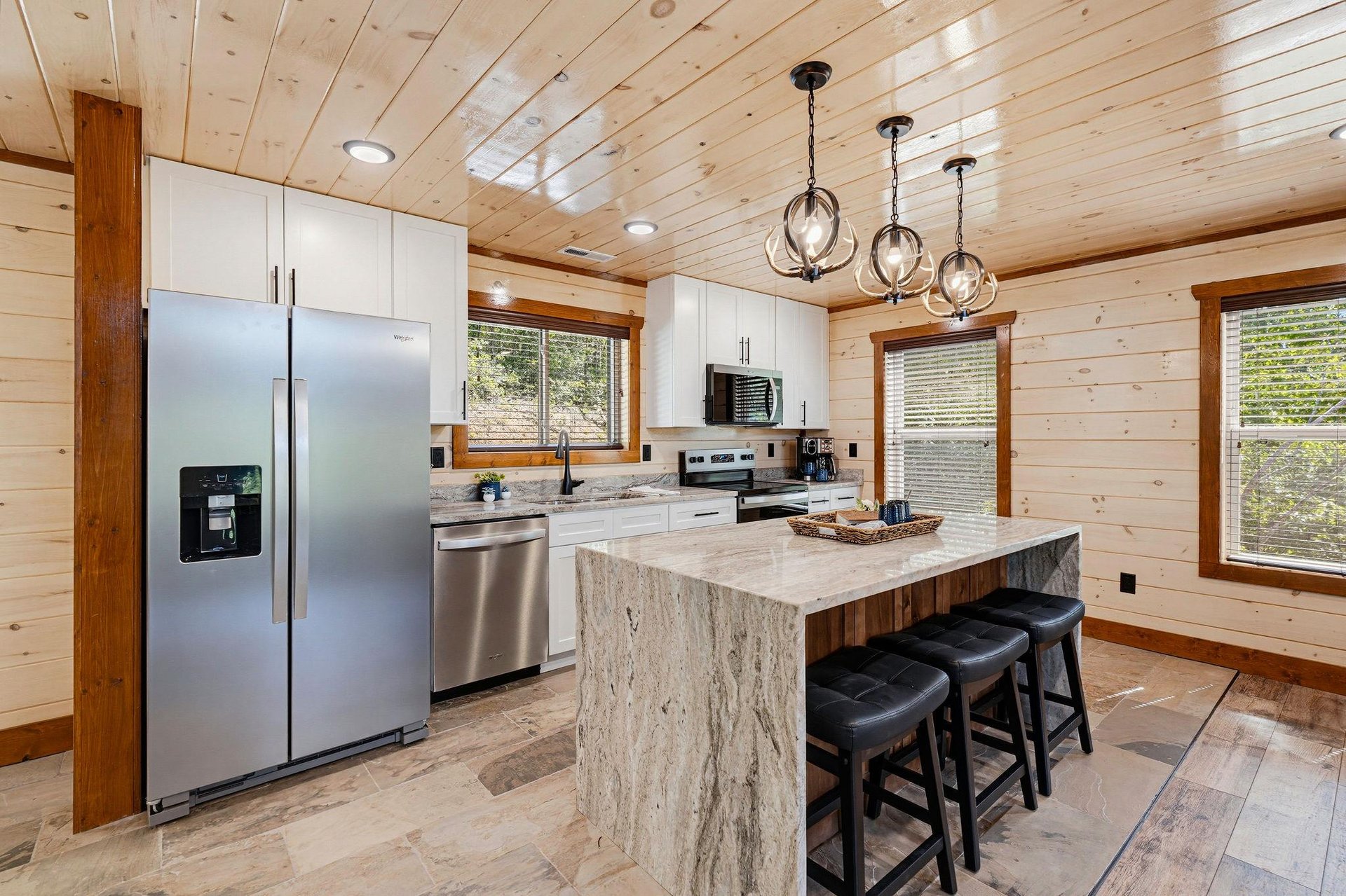 Gather in your fullyequipped kitchen with a stunning marbletopped island, stainless steel appliances, and warm wood accents that make cooking together feel like home.