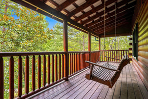 Swing gently on your private covered porch and gaze out at lush forest views—your peaceful retreat from the everyday awaits.