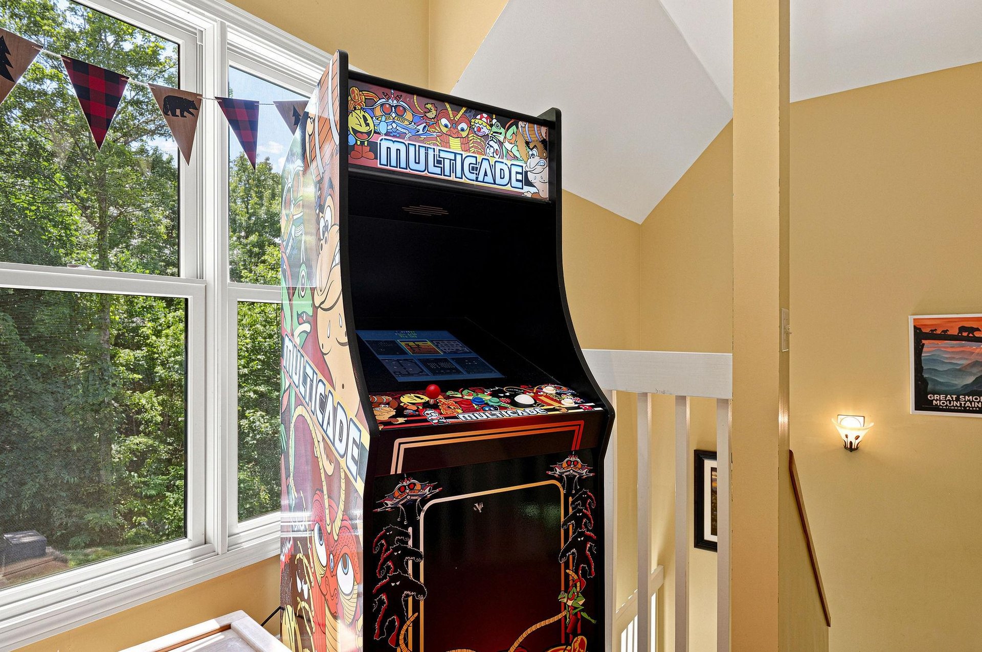 Challenge friends to a game on this classic arcade machine, positioned by a bright window overlooking the trees for perfect natural light during your downtime.